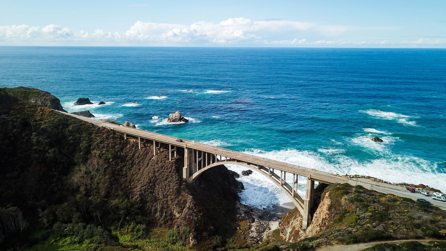 Een brug verbindt twee rotsachtige landtongen aan de kust van Big Sur in Californië.